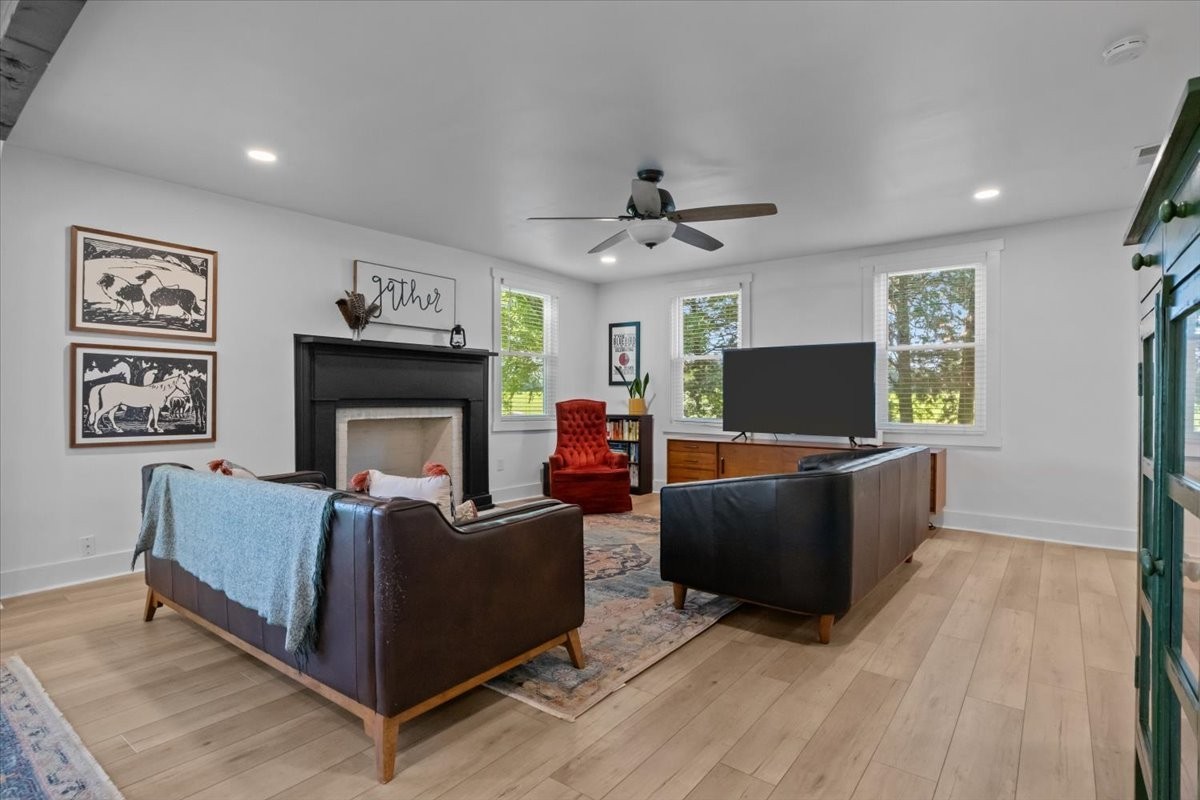 1030 Upper Creek Road Vanleer, TN 37181 - Photo 5 of 38 a living room with furniture a flat screen tv and a fireplace