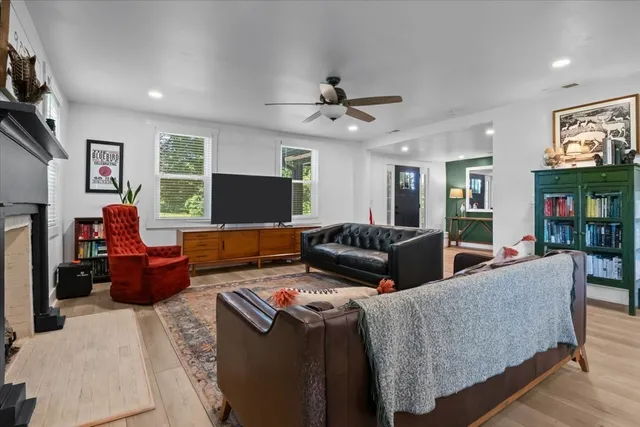 a living room with furniture a flat screen tv and a fireplace