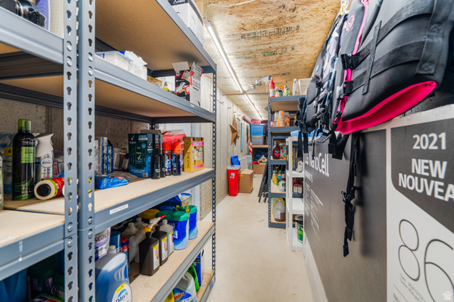 5727 South 3550th Street West Roy, UT 84067 - Photo 25 of 49 Dedicated cold storage area featuring concrete walls, exposed wood-finish ceiling, and industrial-style shelving units