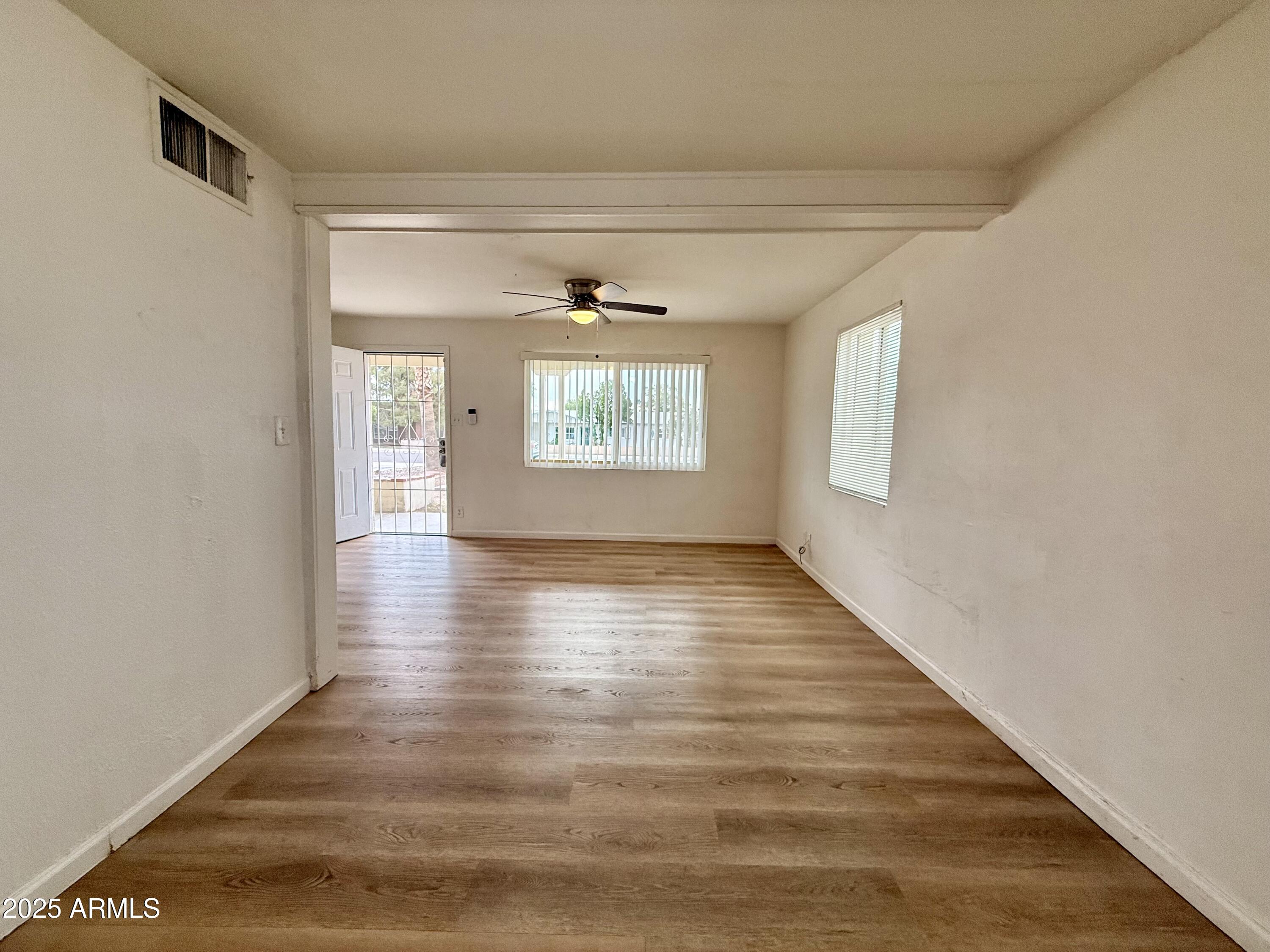 1218 West Cinnabar Avenue Phoenix, AZ 85021 - Photo 15 of 31 a view of an empty room with wooden floor and a window