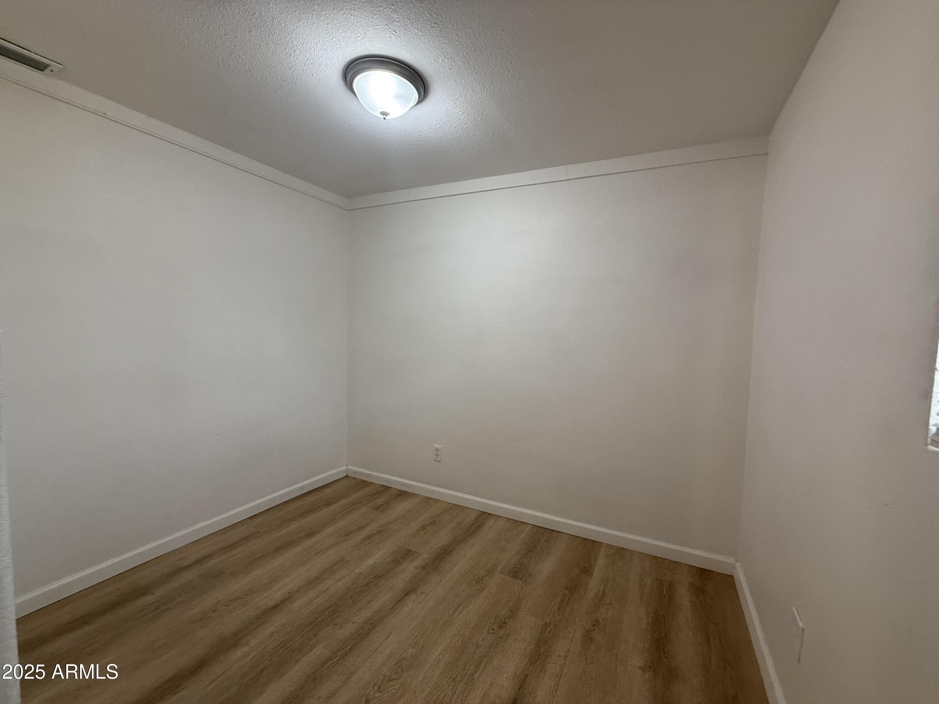 1218 West Cinnabar Avenue Phoenix, AZ 85021 - Photo 16 of 31 a view of room with wooden floor