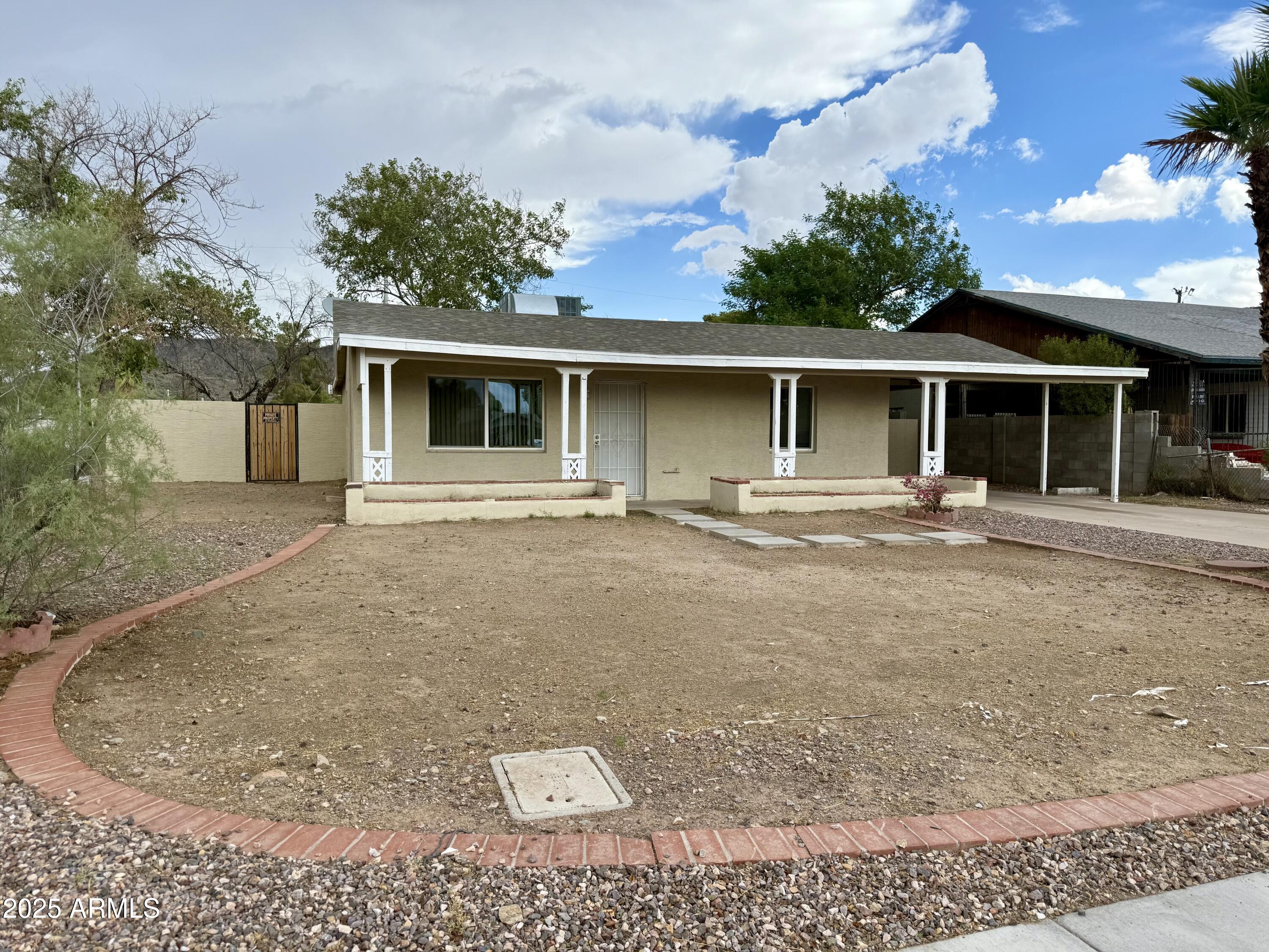 1218 West Cinnabar Avenue Phoenix, AZ 85021 - Photo 2 of 31 a front view of a house with a yard