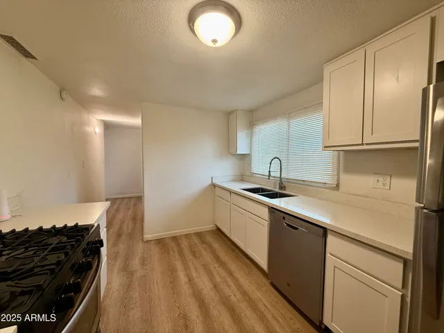 a kitchen that has a sink and a stove