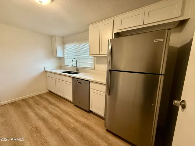 a kitchen with stainless steel appliances a refrigerator and a sink