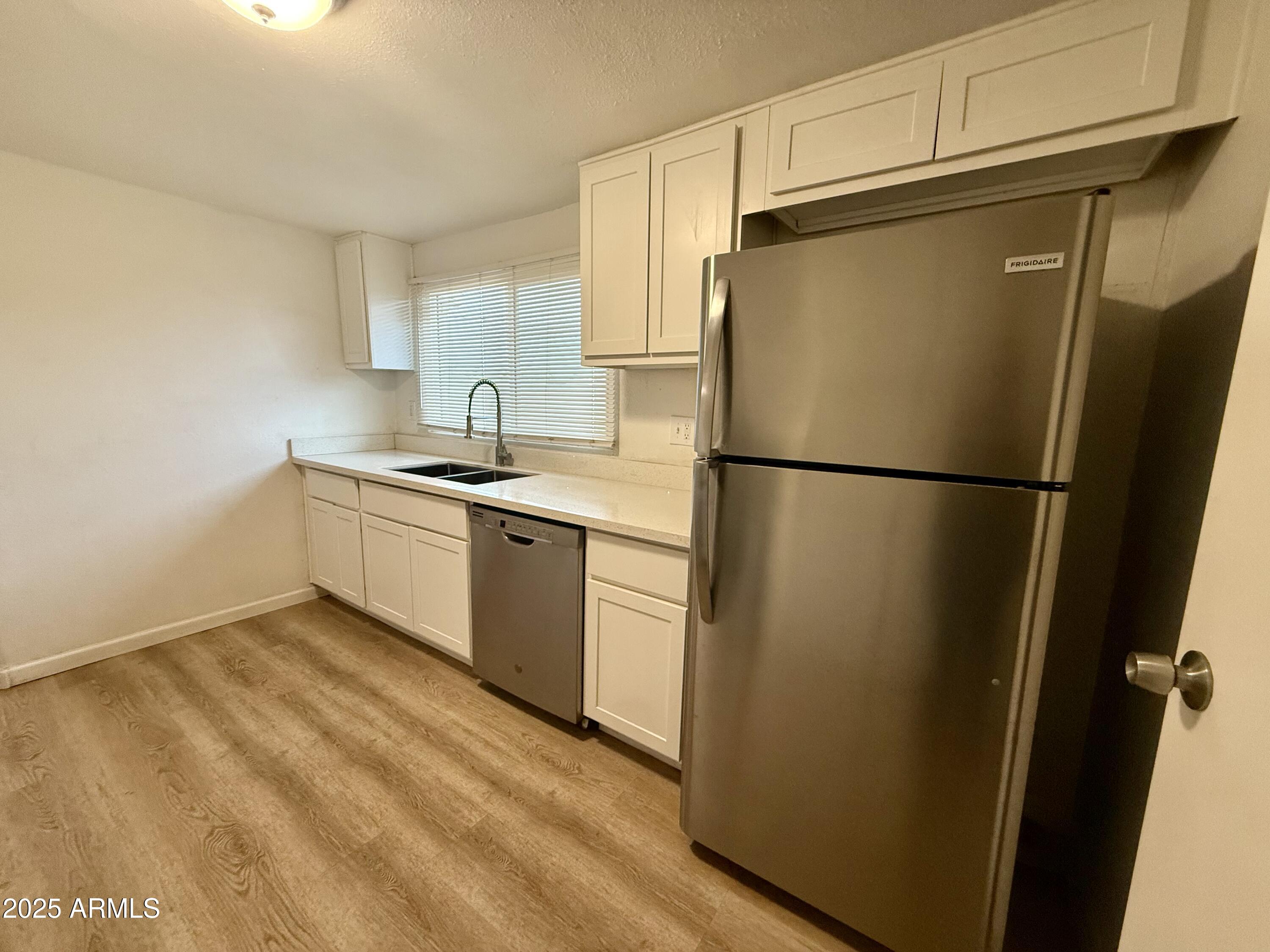 1218 West Cinnabar Avenue Phoenix, AZ 85021 - Photo 22 of 31 a kitchen with stainless steel appliances a refrigerator and a sink