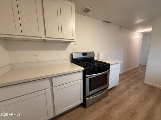 a kitchen with granite countertop stainless steel appliances and wooden cabinets