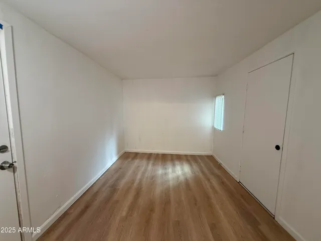 a view of an empty room and wooden floor