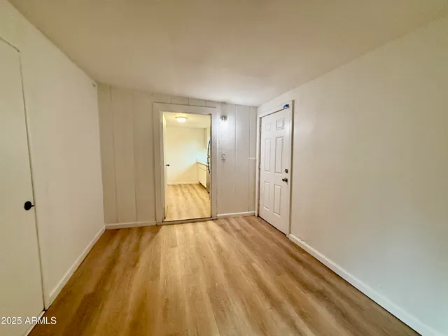 a view of a room with wooden floor and a sink