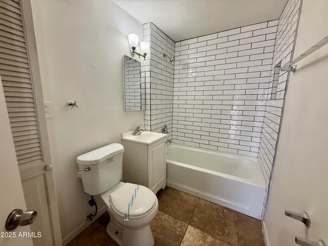 a bathroom with a toilet and shower