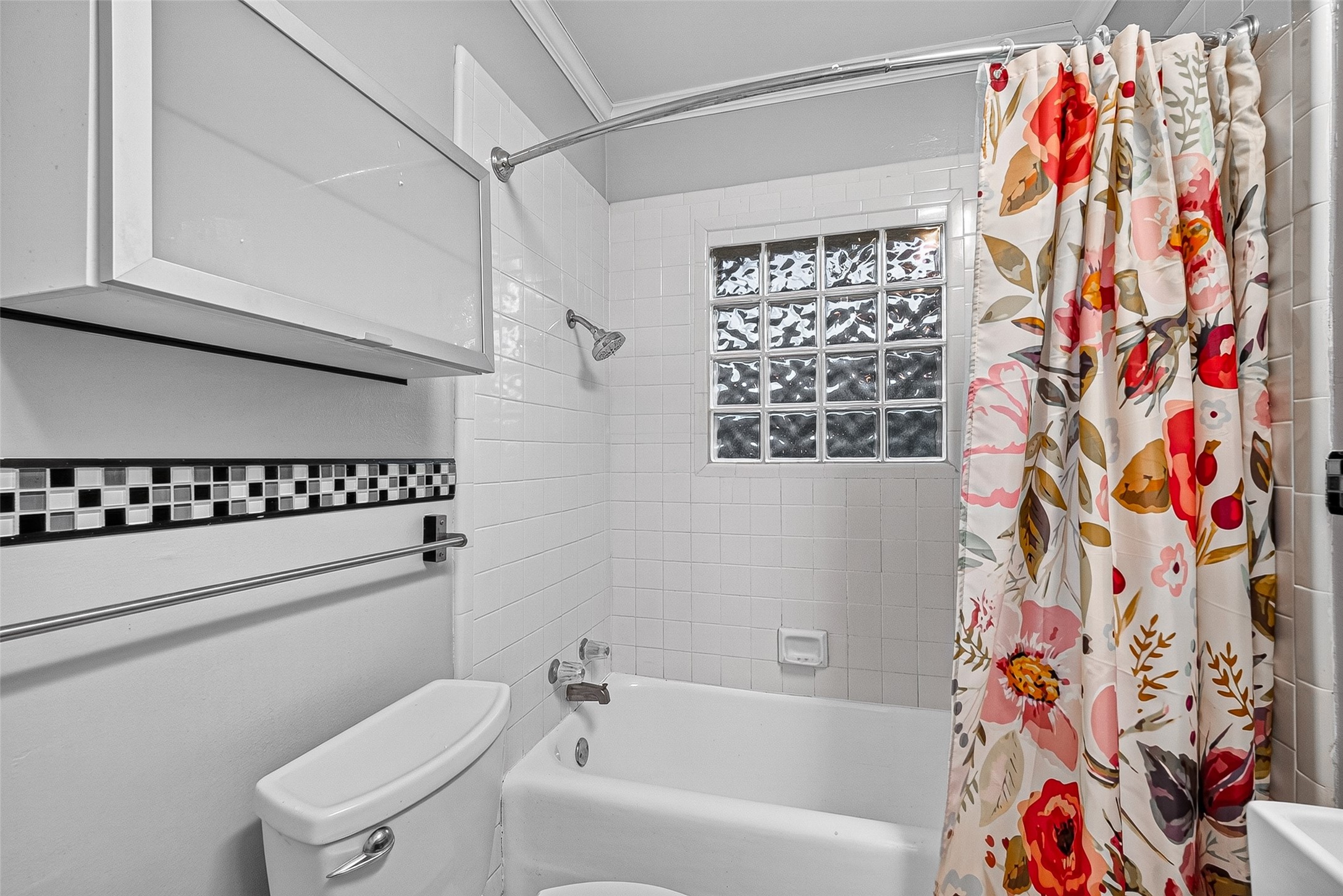 1758 Hawthorne Street, Unit 2 Houston, TX 77098 - Photo 13 of 19 Modern bathroom with a sink, granite countertop, and tiled shower. Features stylish lighting and a sleek tiled design.