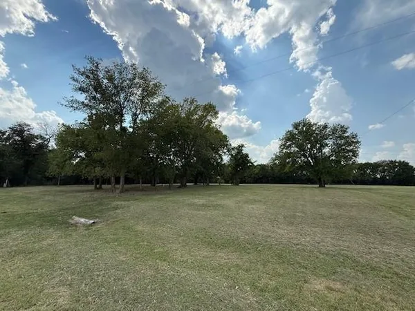 a view of a field with trees