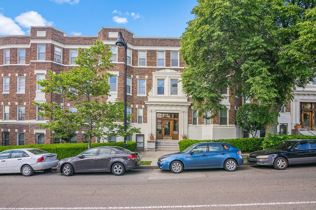 1673 Commonwealth Avenue, Unit 3 Boston, MA 02135 - Photo 3 of 10 a car parked in front of a big house
