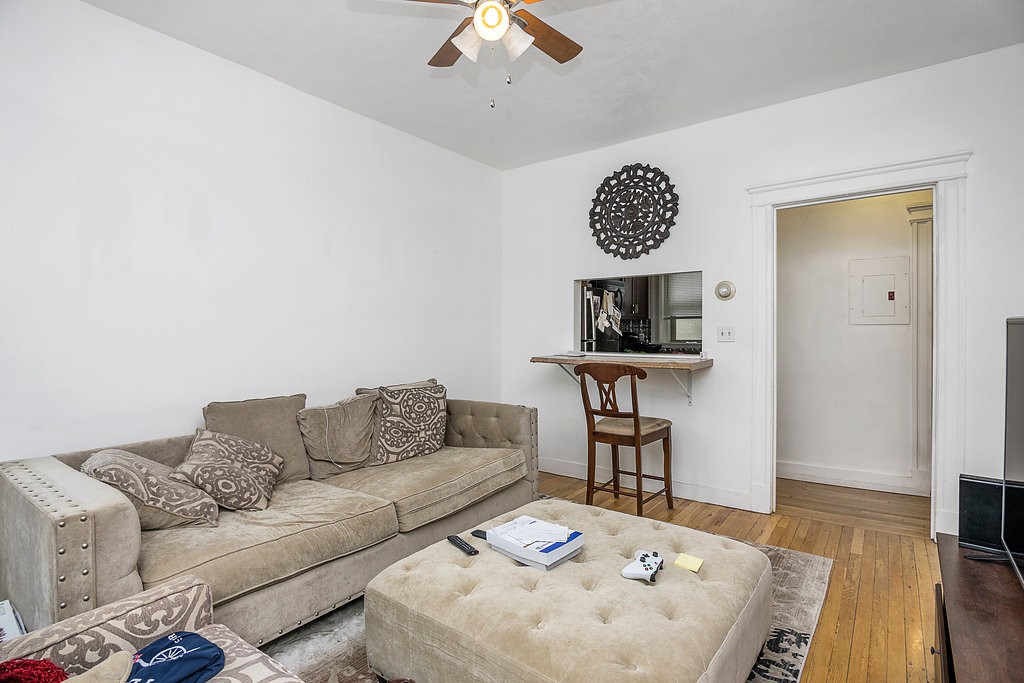 1673 Commonwealth Avenue, Unit 3 Boston, MA 02135 - Photo 4 of 10 a living room with furniture a rug and a table