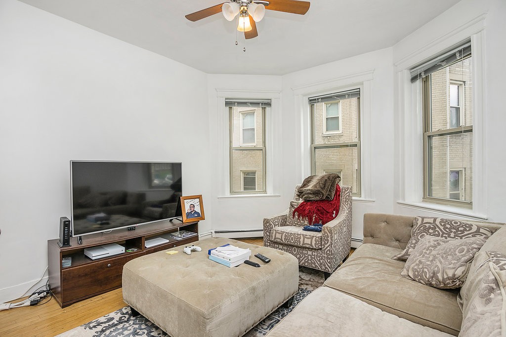 1673 Commonwealth Avenue, Unit 3 Boston, MA 02135 - Photo 5 of 10 a living room with furniture and a flat screen tv