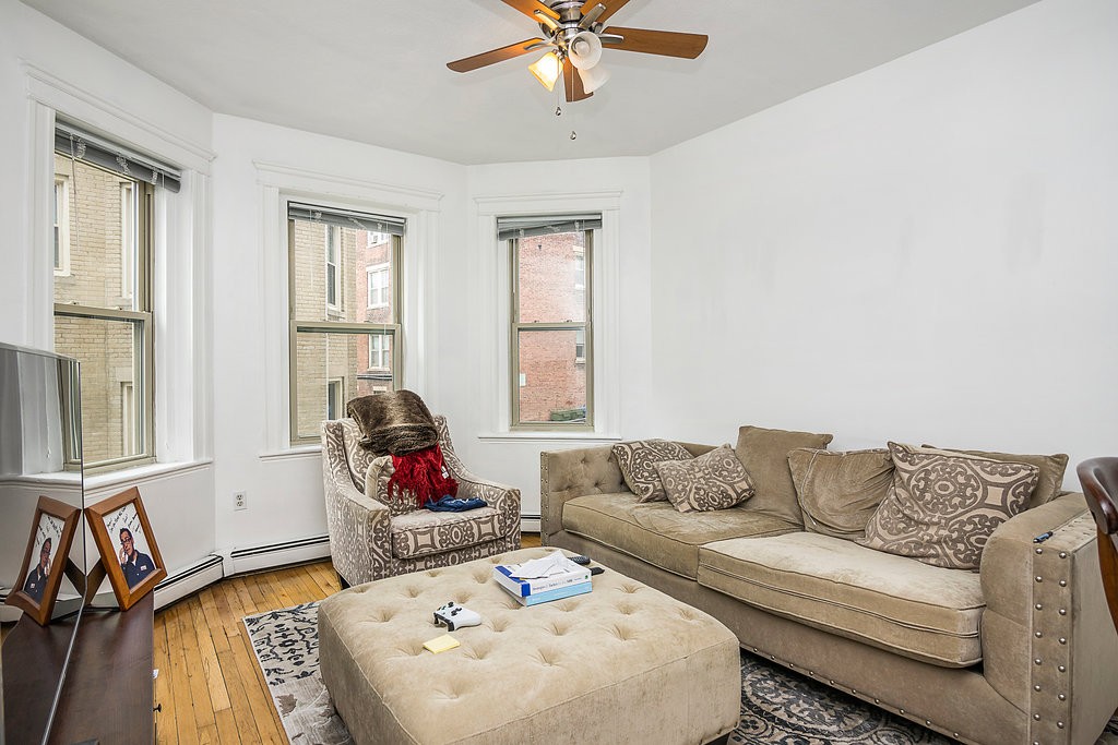 1673 Commonwealth Avenue, Unit 3 Boston, MA 02135 - Photo 6 of 10 a living room with furniture and a window