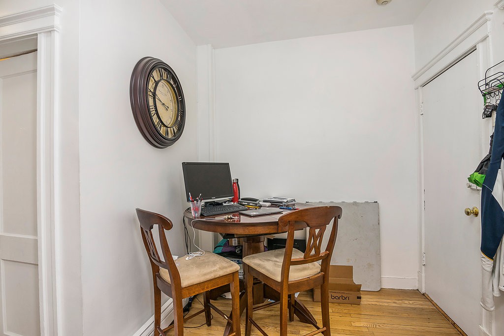 1673 Commonwealth Avenue, Unit 3 Boston, MA 02135 - Photo 8 of 10 a dining room with furniture and a mirror