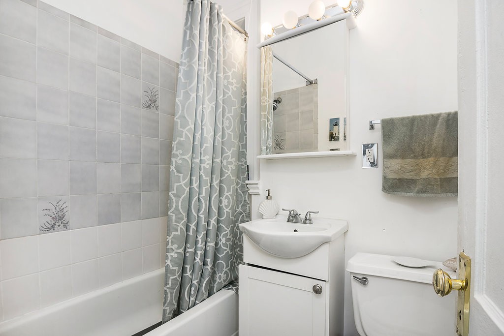 1673 Commonwealth Avenue, Unit 3 Boston, MA 02135 - Photo 10 of 10 a bathroom with a sink toilet and shower
