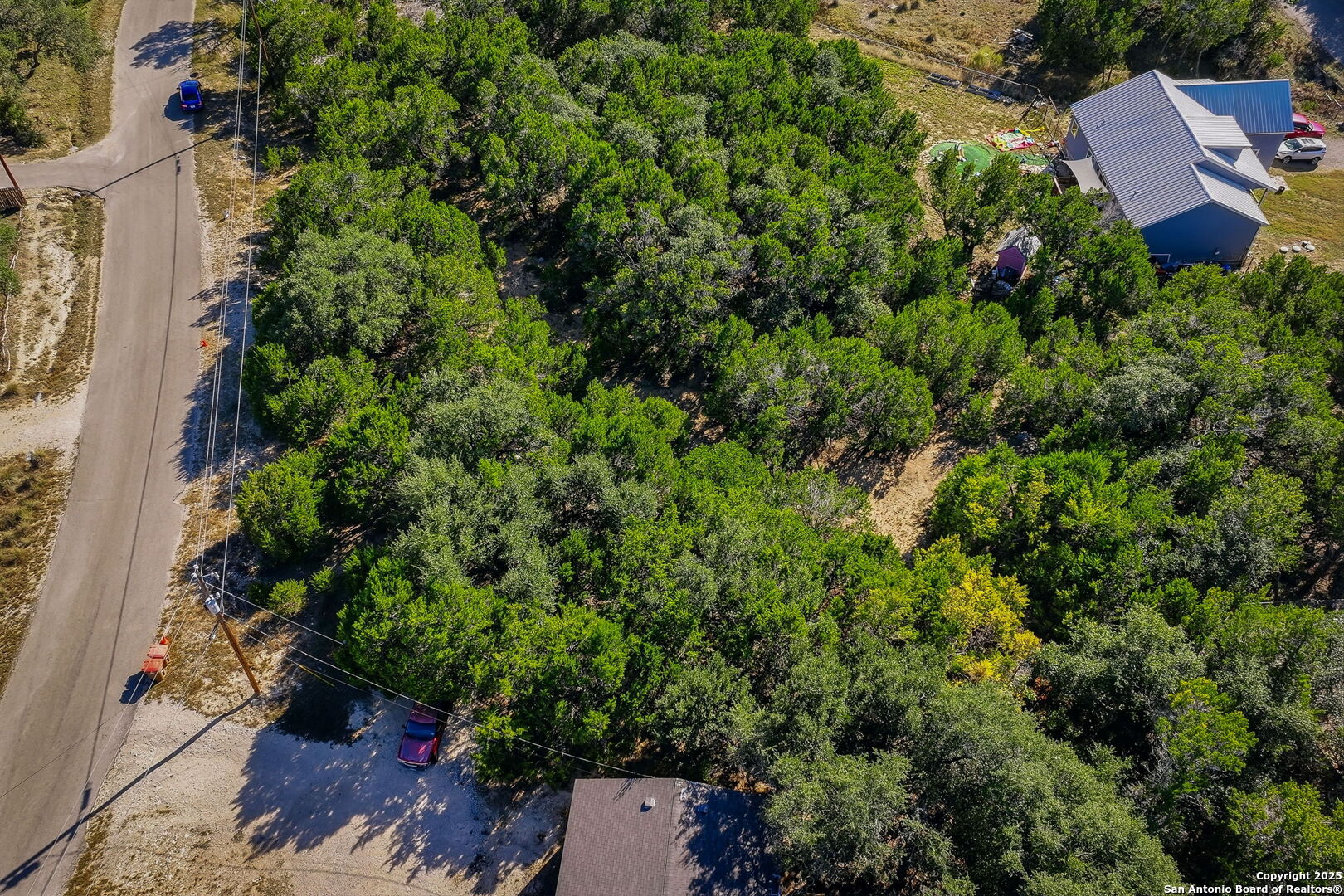 354 Buck Run Pass Canyon Lake, TX 78133 - Photo 4 of 16 an aerial view of a house with a yard and outdoor seating