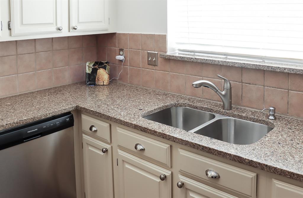 5565 Preston Oaks Road, Unit 120 Dallas, TX 75254 - Photo 5 of 27 Kitchen with stainless steel double-basin sink and a coordinating tile backsplash
