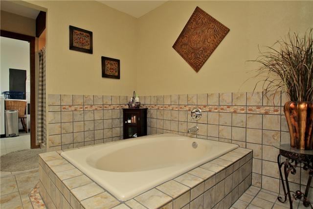 1174 Dimple Road Chapmansboro, TN 37035 - Photo 17 of 20 Master bath has separate shower, whirlpool tub, tiled floors, and double vanities