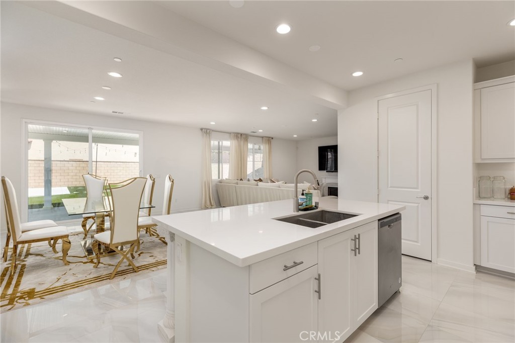 31124 Hanover Lane Menifee, CA 92584 - Photo 10 of 39 a kitchen with a stove a sink a table and chairs