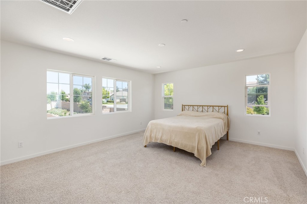 31124 Hanover Lane Menifee, CA 92584 - Photo 14 of 39 a bed sitting in a spacious bedroom next to a window
