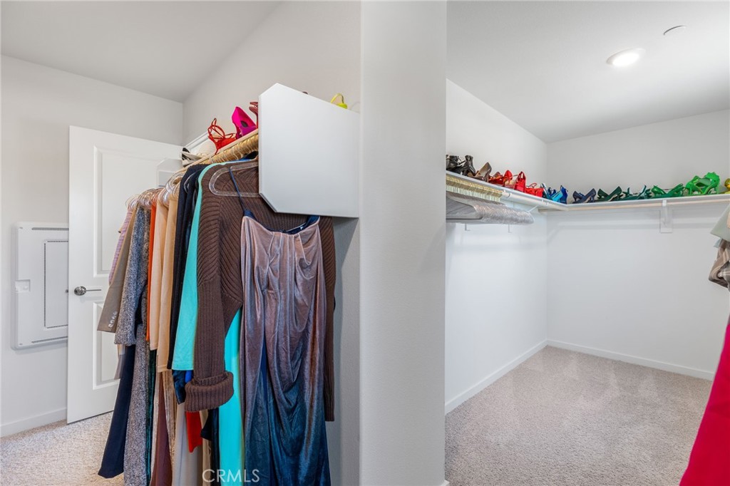 31124 Hanover Lane Menifee, CA 92584 - Photo 18 of 39 a view of walk in closet with clothes and shoes