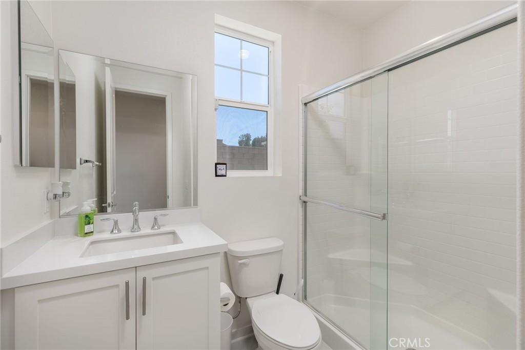 31124 Hanover Lane Menifee, CA 92584 - Photo 20 of 39 a bathroom with a sink a toilet and shower