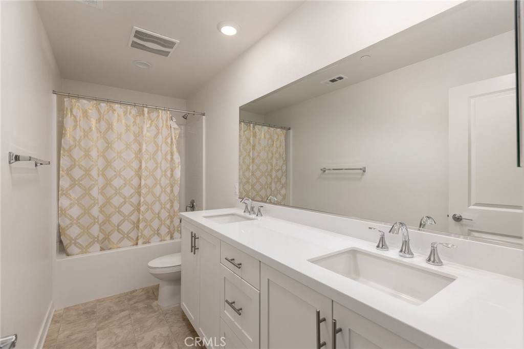 31124 Hanover Lane Menifee, CA 92584 - Photo 23 of 39 a bathroom with a double vanity sink toilet and shower