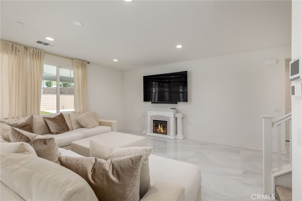 31124 Hanover Lane Menifee, CA 92584 - Photo 6 of 39 a living room with furniture fireplace and flat screen tv
