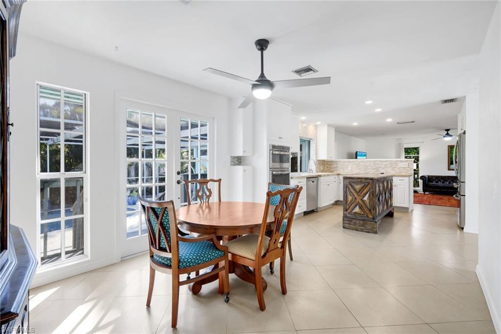 4352 Parrot Avenue Naples, FL 34104 - Photo 12 of 27 a view of a dining room with furniture and a chandelier