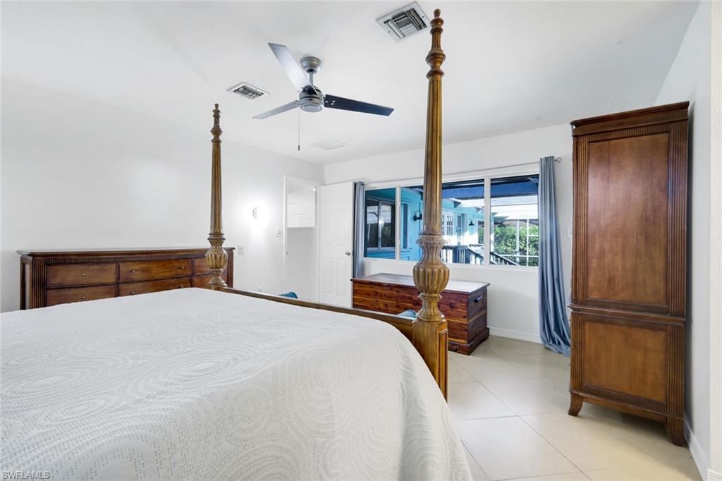 4352 Parrot Avenue Naples, FL 34104 - Photo 14 of 27 a bedroom with a bed and furniture