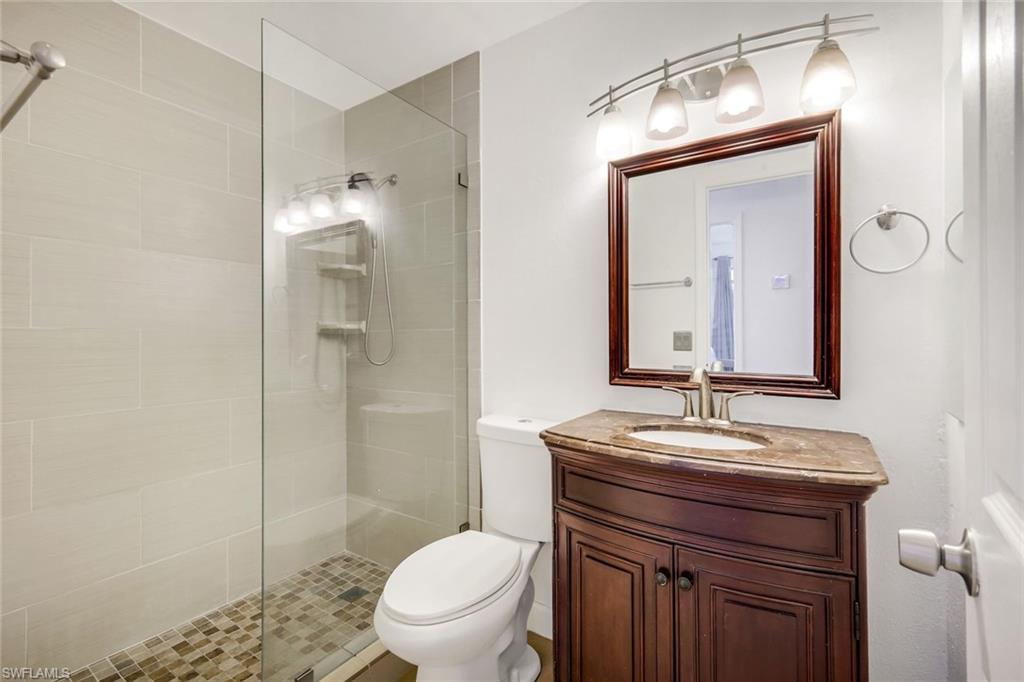 4352 Parrot Avenue Naples, FL 34104 - Photo 17 of 27 a bathroom with a sink a toilet and shower