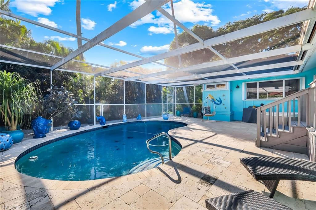 4352 Parrot Avenue Naples, FL 34104 - Photo 2 of 27 a view of a swimming pool with a patio and a backyard