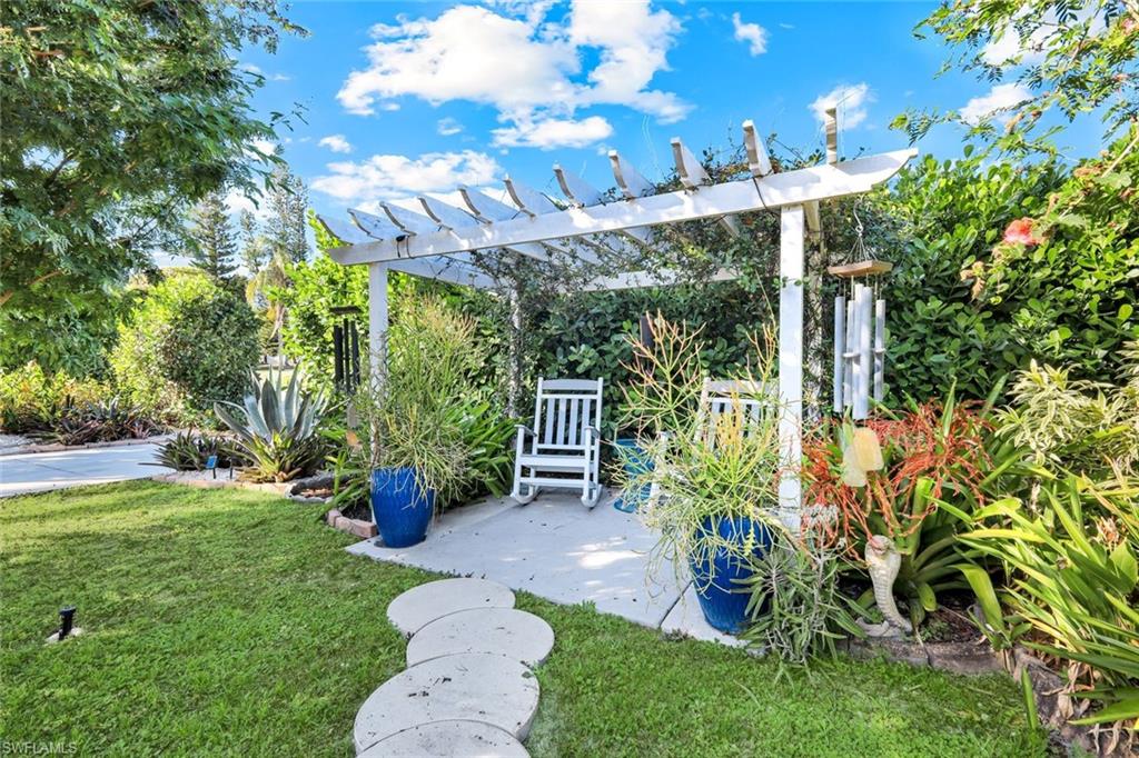 4352 Parrot Avenue Naples, FL 34104 - Photo 22 of 27 a view of a chair and table in the garden