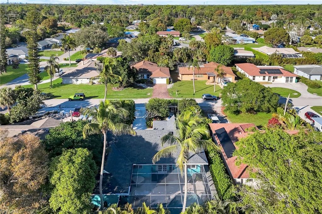 4352 Parrot Avenue Naples, FL 34104 - Photo 23 of 27 an aerial view of residential houses with outdoor space and trees
