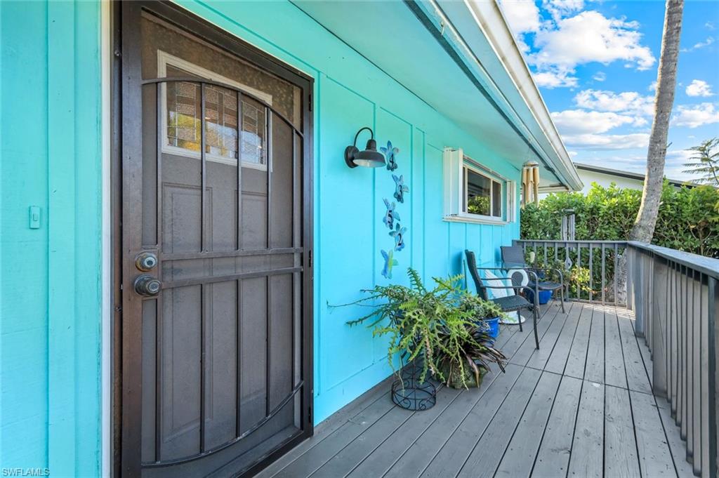 4352 Parrot Avenue Naples, FL 34104 - Photo 5 of 27 a view of balcony with furniture and wooden floor
