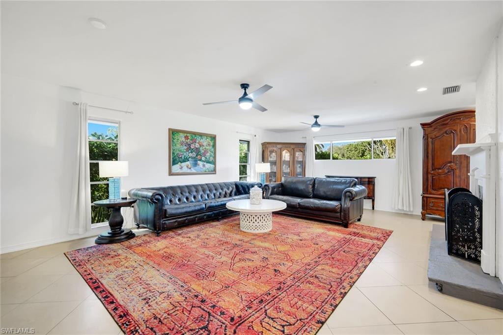 4352 Parrot Avenue Naples, FL 34104 - Photo 7 of 27 a living room with furniture and a fireplace