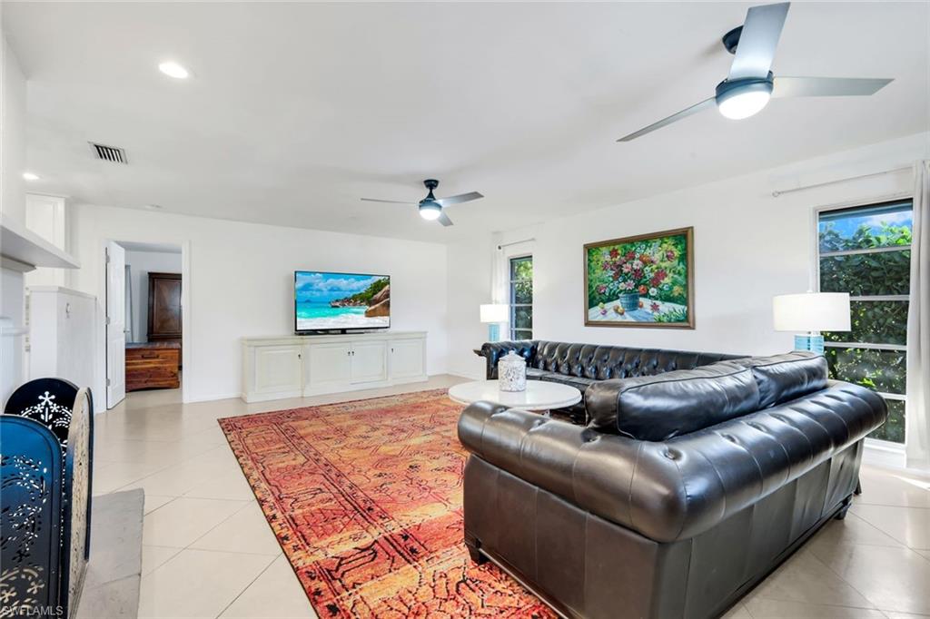 4352 Parrot Avenue Naples, FL 34104 - Photo 8 of 27 a living room with furniture and a flat screen tv