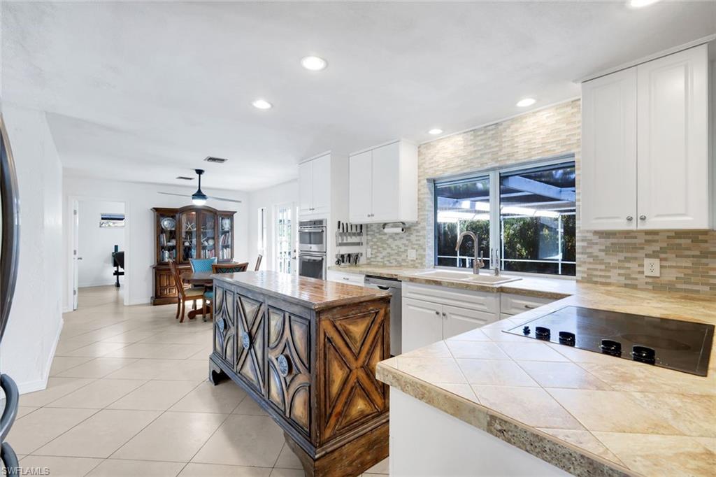 4352 Parrot Avenue Naples, FL 34104 - Photo 9 of 27 a kitchen that has a lot of cabinets in it and appliances