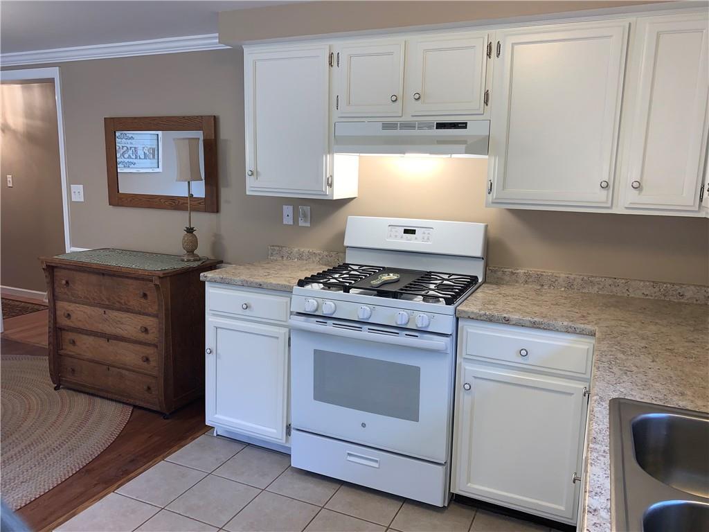 1708 Dime Road Vandergrift, PA 15690 - Photo 9 of 25 a kitchen with granite countertop white cabinets and white appliances
