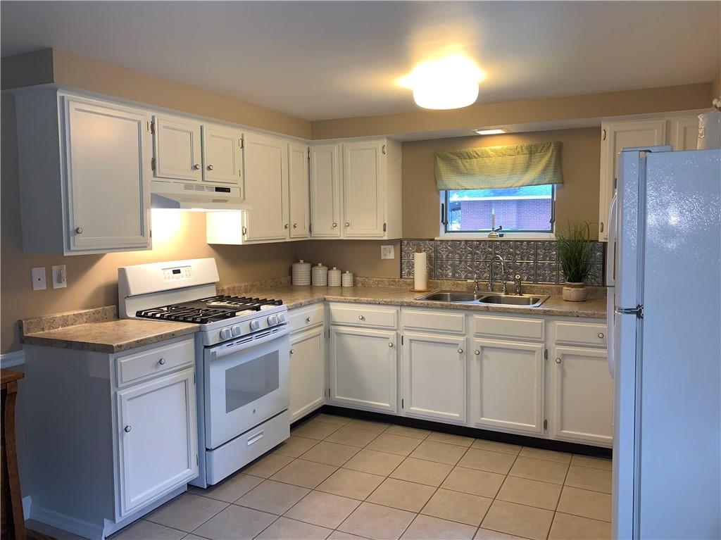1708 Dime Road Vandergrift, PA 15690 - Photo 10 of 25 a kitchen with stainless steel appliances granite countertop a stove a sink and a refrigerator