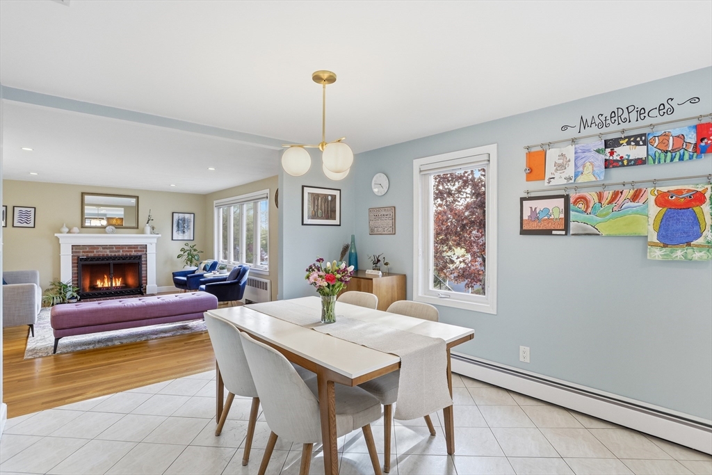 115 Collincote Street Stoneham, MA 02180 - Photo 7 of 25 a view of a dining room with furniture a chandelier and wooden floor