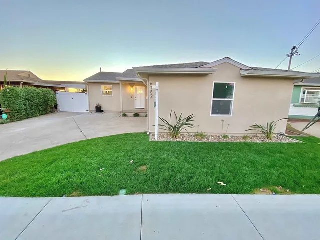 a front view of house with yard and outdoor seating