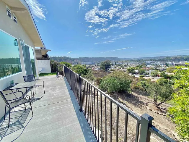 a view of a dry yard with trees