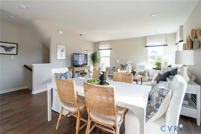 a dining room with furniture and wooden floor