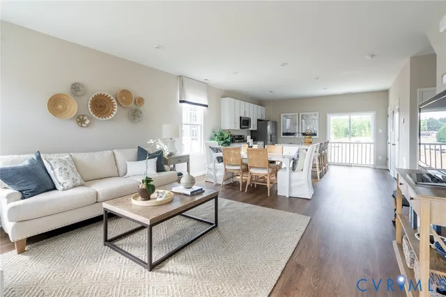 a living room with furniture wooden floor and a table