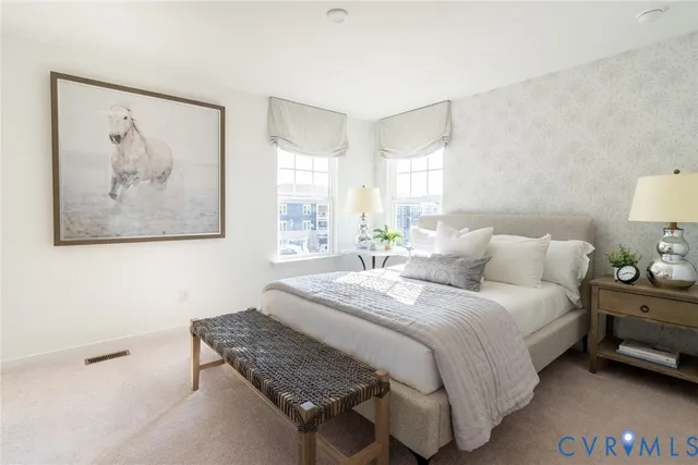 a bedroom with a bed and a painting on the wall