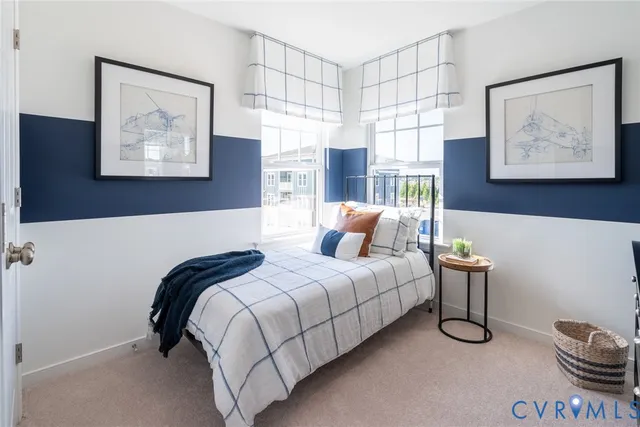 a bedroom with a bed and painting on the wall