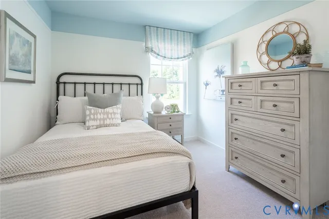 a bedroom with a bed and a dresser